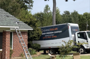 Photo of Shine Solar truck beside house